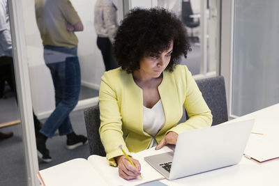 Woman using laptop in boardroom