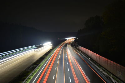 High angle view of light trails on road at night