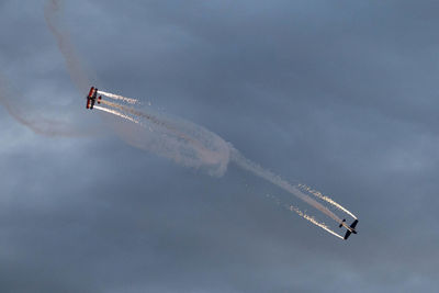 Low angle view of airplane flying against sky