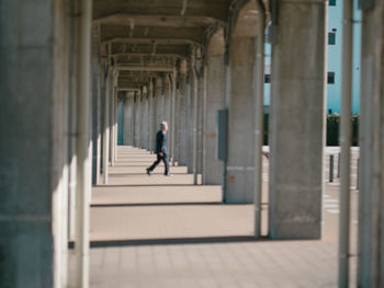 Man walking in corridor of building