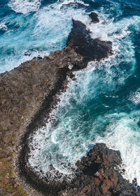 High angle view of rock formations in sea