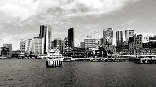 Cityscape against cloudy sky