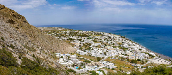 Scenic view of sea by cliff against sky