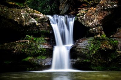 Scenic view of waterfall in forest hocking hills state park
