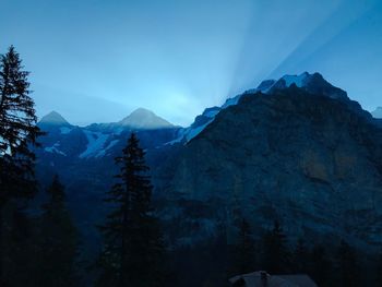 Scenic view of snowcapped mountains against blue sky