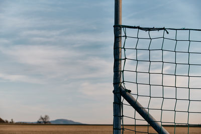 Low angle view of basketball hoop on field against sky