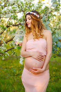 Pregnant woman standing outdoors