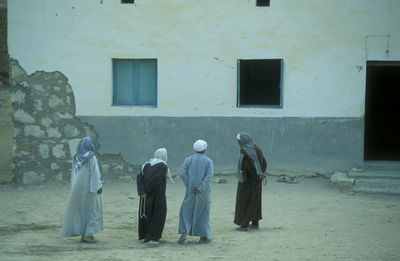 Rear view of people walking on street