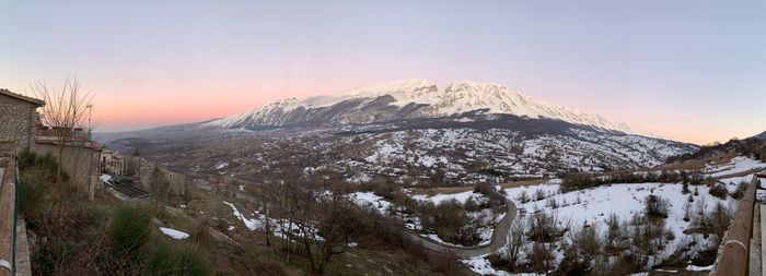 Scenic view of snowcapped mountains against sky during sunset