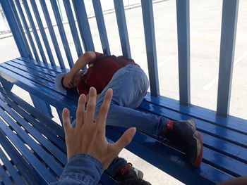 High angle view of man lying on bench