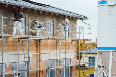 Workers at incomplete construction site