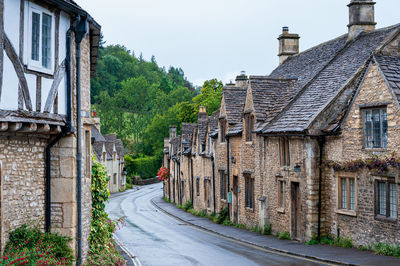 Road amidst buildings against sky