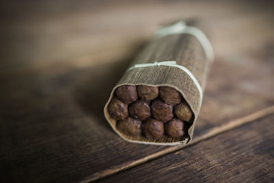 Close-up of cigars on wooden table