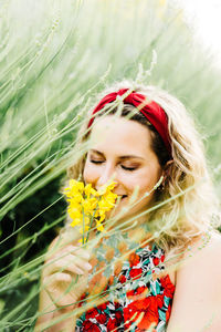 Portrait of beautiful woman with red flower