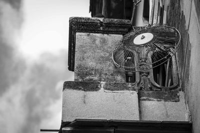 Close-up of old machine part against sky