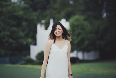 Portrait of smiling young woman standing outdoors