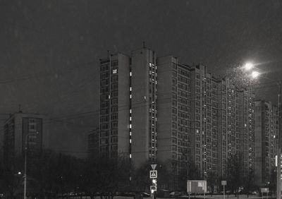 Low angle view of illuminated building against sky at night