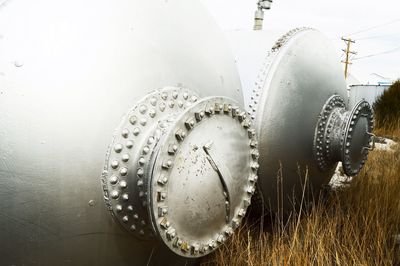 Close-up of fuel storage tank on field