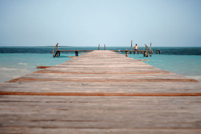 Pier on sea against clear sky