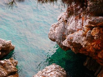 Scenic view of rocky mountain by sea