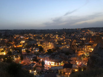 High angle shot of illuminated cityscape against sky at dusk