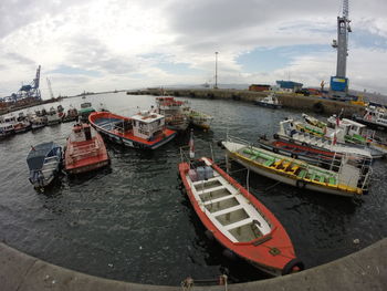 Boats moored on sea against sky