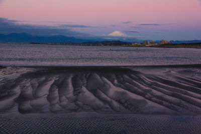 Scenic view of beach against sky during sunset