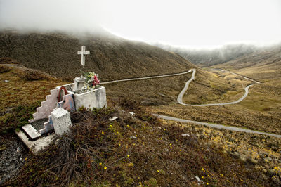 High angle view of grave against remote landscape