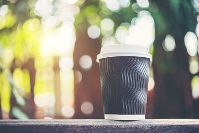 Close-up of disposable cup on retaining wall
