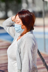 Midsection of woman standing outdoors