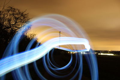 Light trails against sky at night