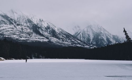 Scenic view of snow covered mountains against sky