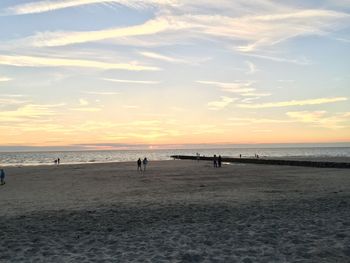 Scenic view of beach against sky during sunset