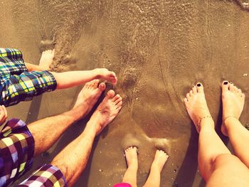 Low section of family on sea shore