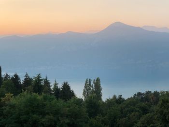 Scenic view of mountains against sky at sunset