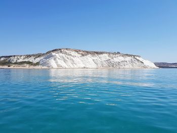 Scenic view of sea against clear blue sky