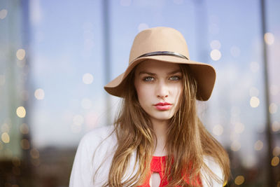 Portrait of young woman wearing hat