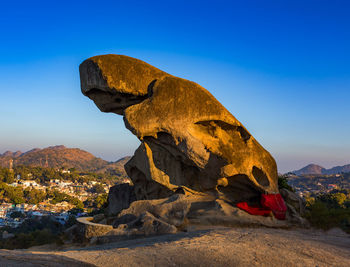 Rock formation on mountain against clear blue sky