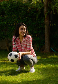 Portrait of smiling young woman in field