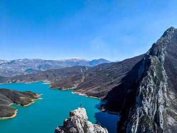 Panoramic view of lake and mountains against blue sky