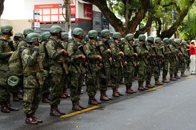 Rear view of military walking on street