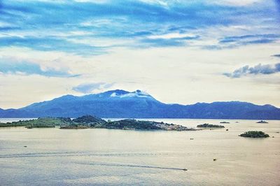 Scenic view of mountains against cloudy sky