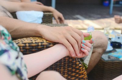 Cropped image couple holding hands at cafe