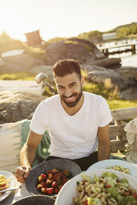 Portrait of young man eating food