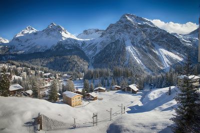 Panoramic view of snowcapped mountains against blue sky