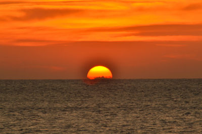 Scenic view of sea against romantic sky at sunset