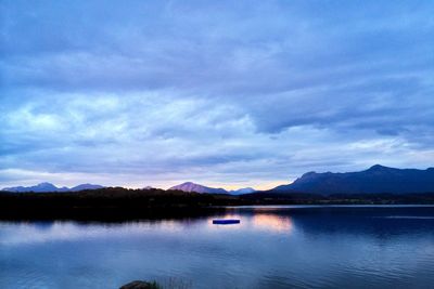 Scenic view of calm lake against mountain range