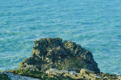 High angle view of rocks by sea