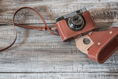 High angle view of antique camera with cover on table