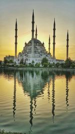 Reflection of church in lake at sunset